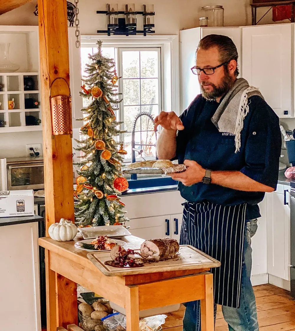 Photo: chef Starson Roy plating in the kitchen